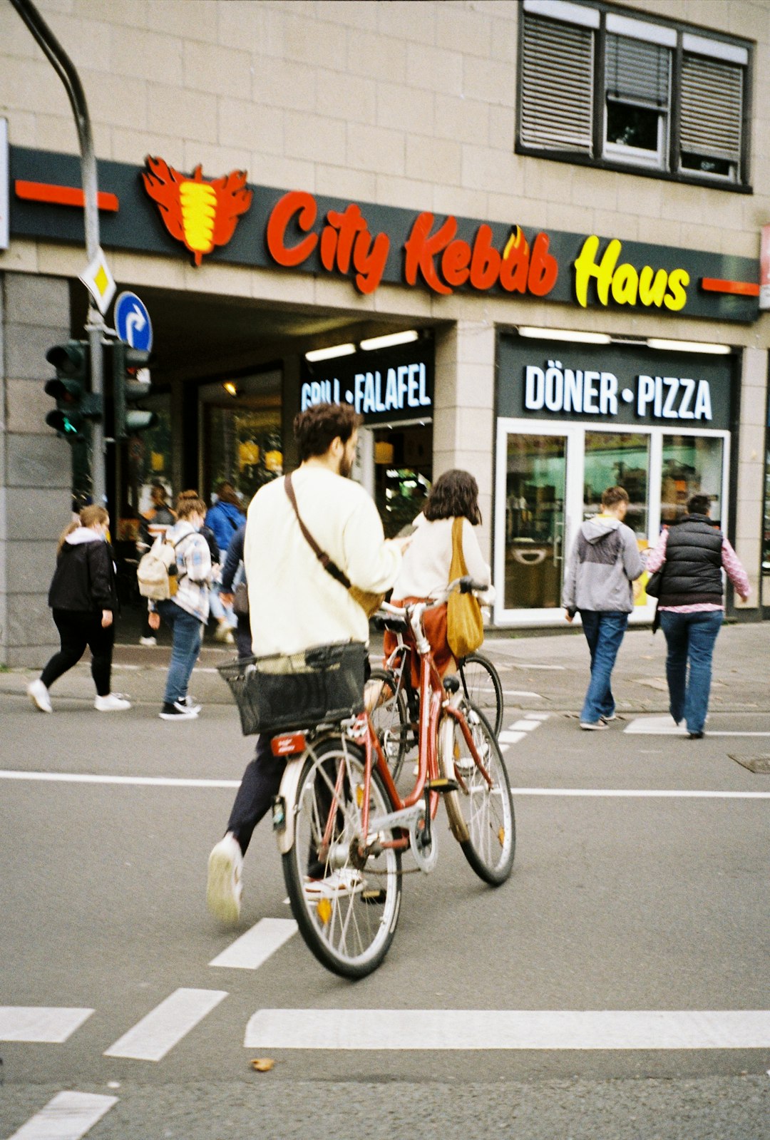 man in white dress shirt riding on bicycle during daytime