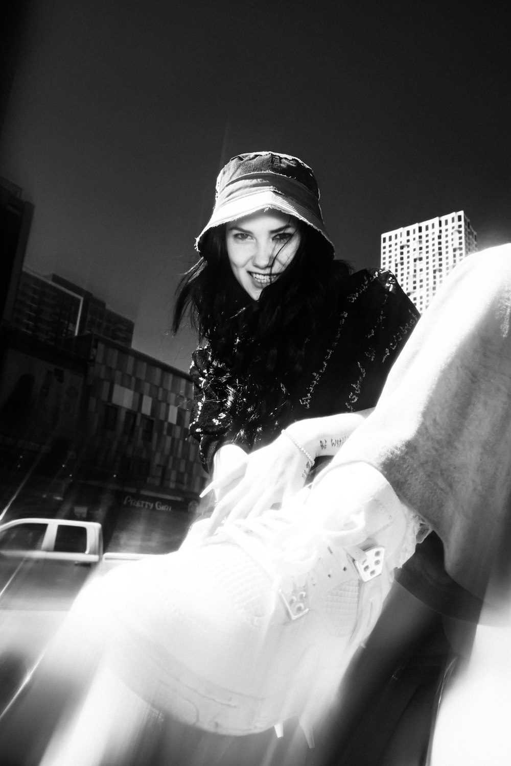 grayscale photo of woman in white long sleeve shirt and black knit cap