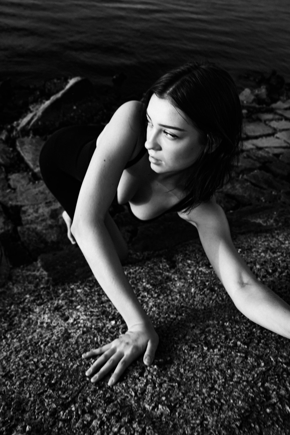 woman in black tank top lying on ground