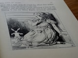 An illustration on a page from a book, depicting a young girl with long hair wearing a dress, sitting on the ground while looking towards a rabbit running away. The scene is sketched in a classic style, and the surrounding text describes the 'Pool of Tears' chapter.