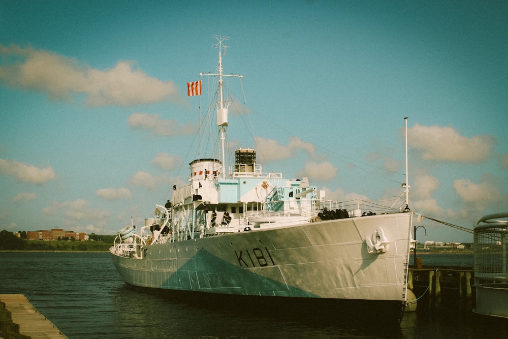 white ship on sea under blue sky during daytime