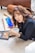 woman in black blazer holding blue smartphone