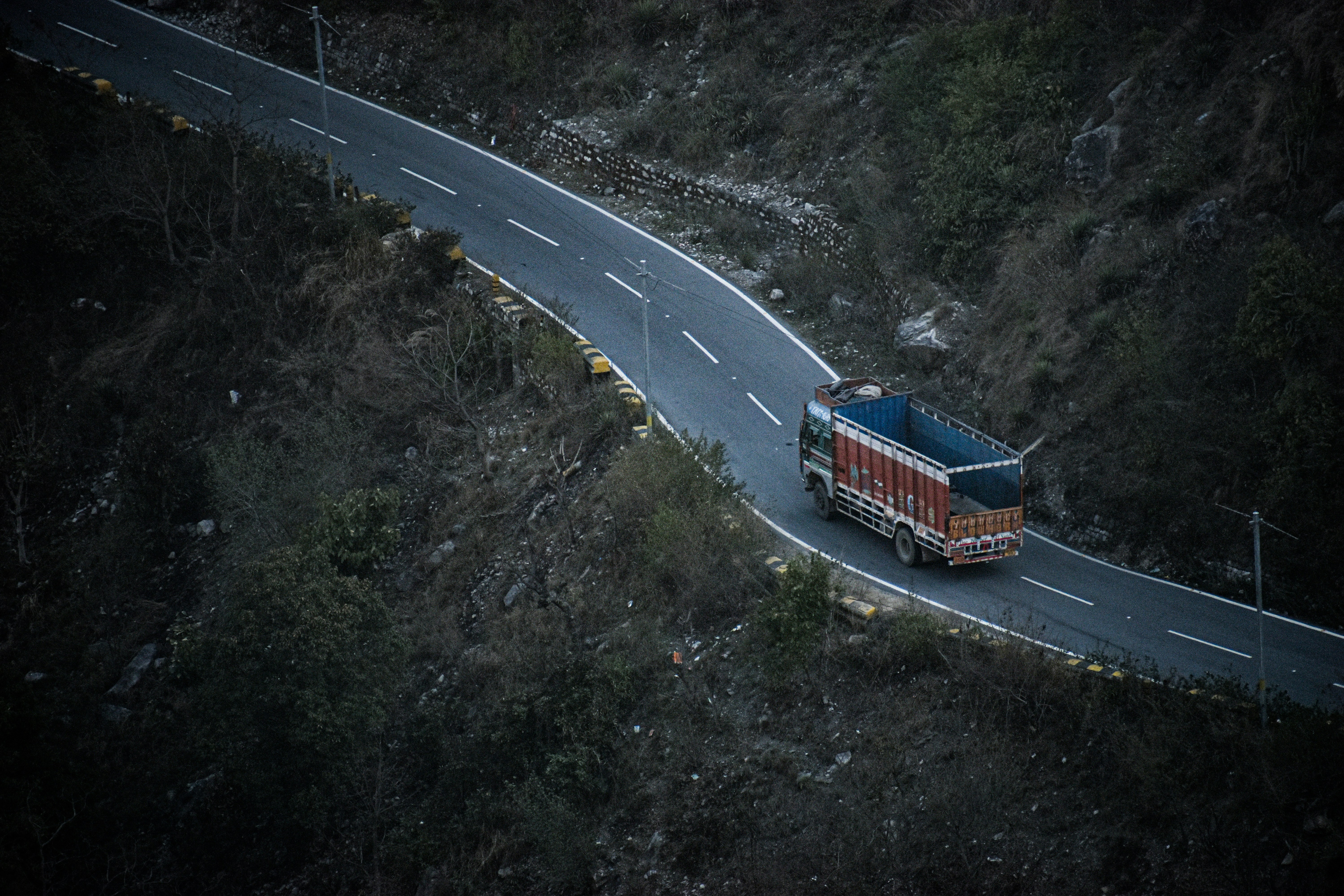 red and blue bus on road during daytime