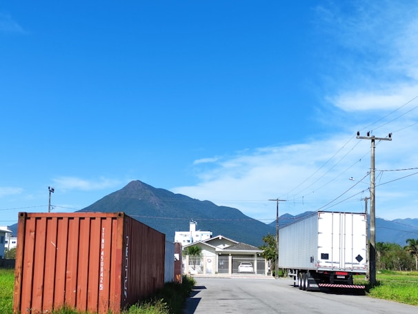 A scenic view of a cargo truck on a highway.