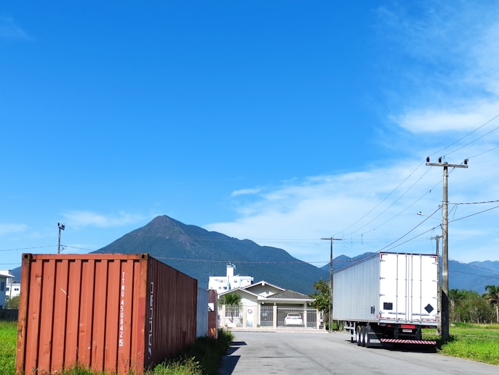 A scenic view of a cargo truck on a highway.