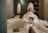 woman in white robe sitting on white couch