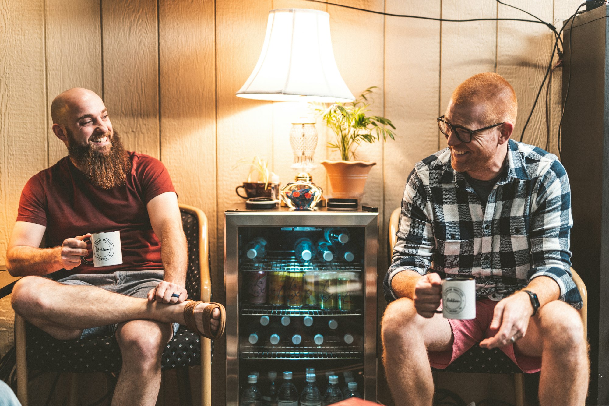 Two men chatting while enjoying a drink