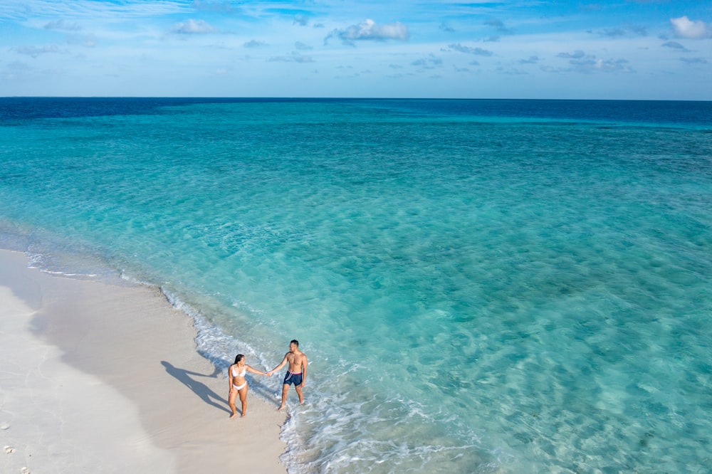 2 women in beach during daytime