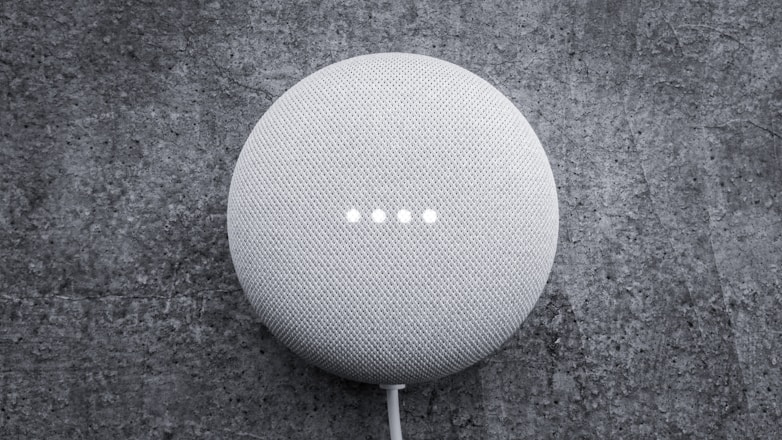 round white portable speaker on black textile. Voice search. voice assistant. Marketing. Trends. 
