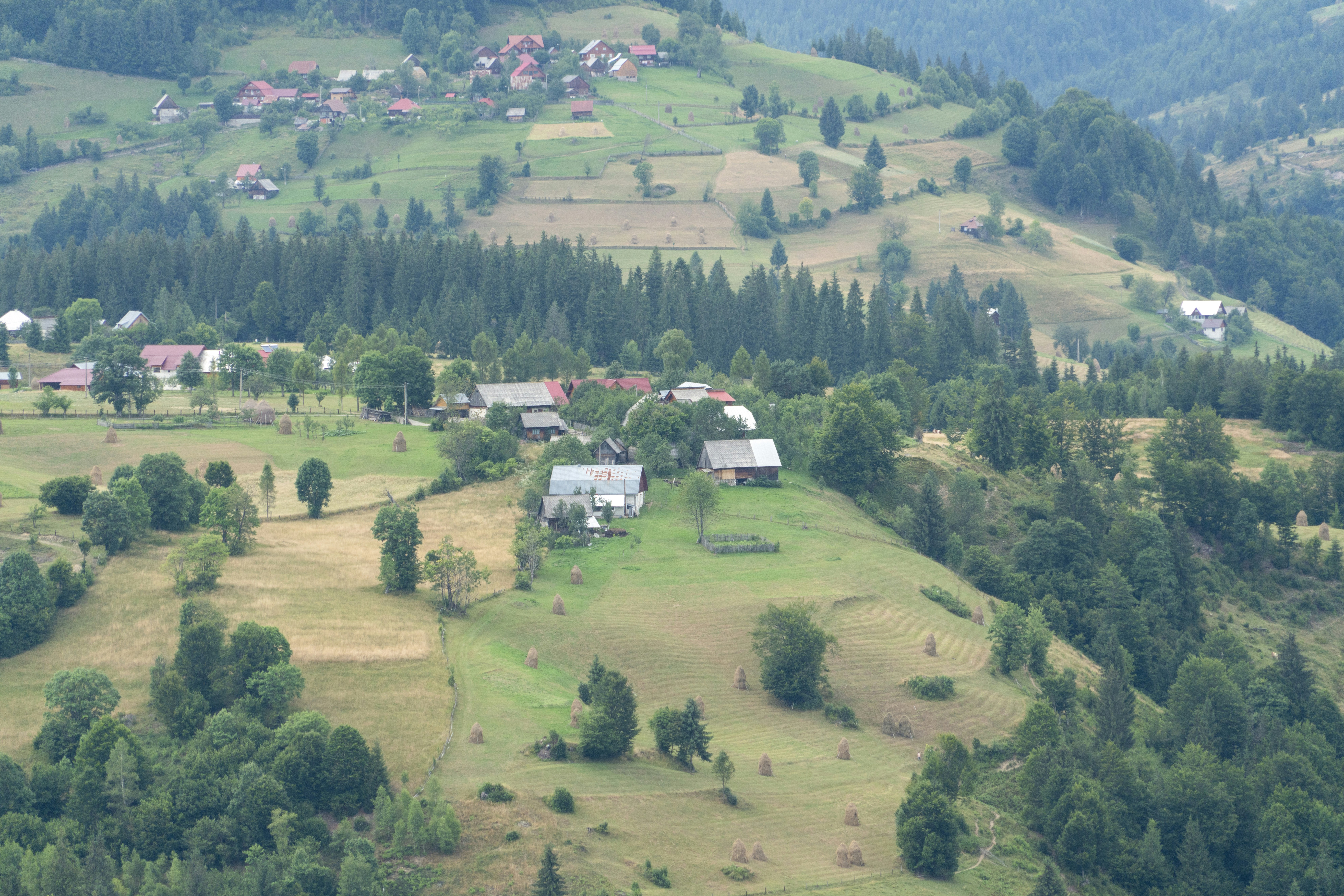 an aerial view of a small village in the mountains