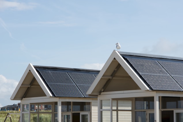 white and black wooden house with roof sol panels