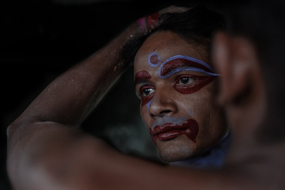 woman with red and blue face paint