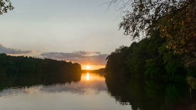 A serene vacation scene with golden sunlight over a calm lake, reflecting peace, prosperity, and resilience.