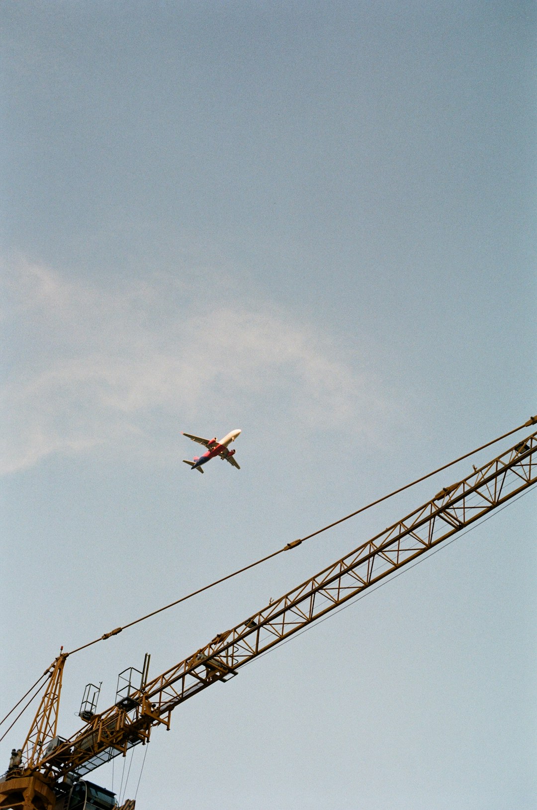 white and red airplane flying in the sky during daytime