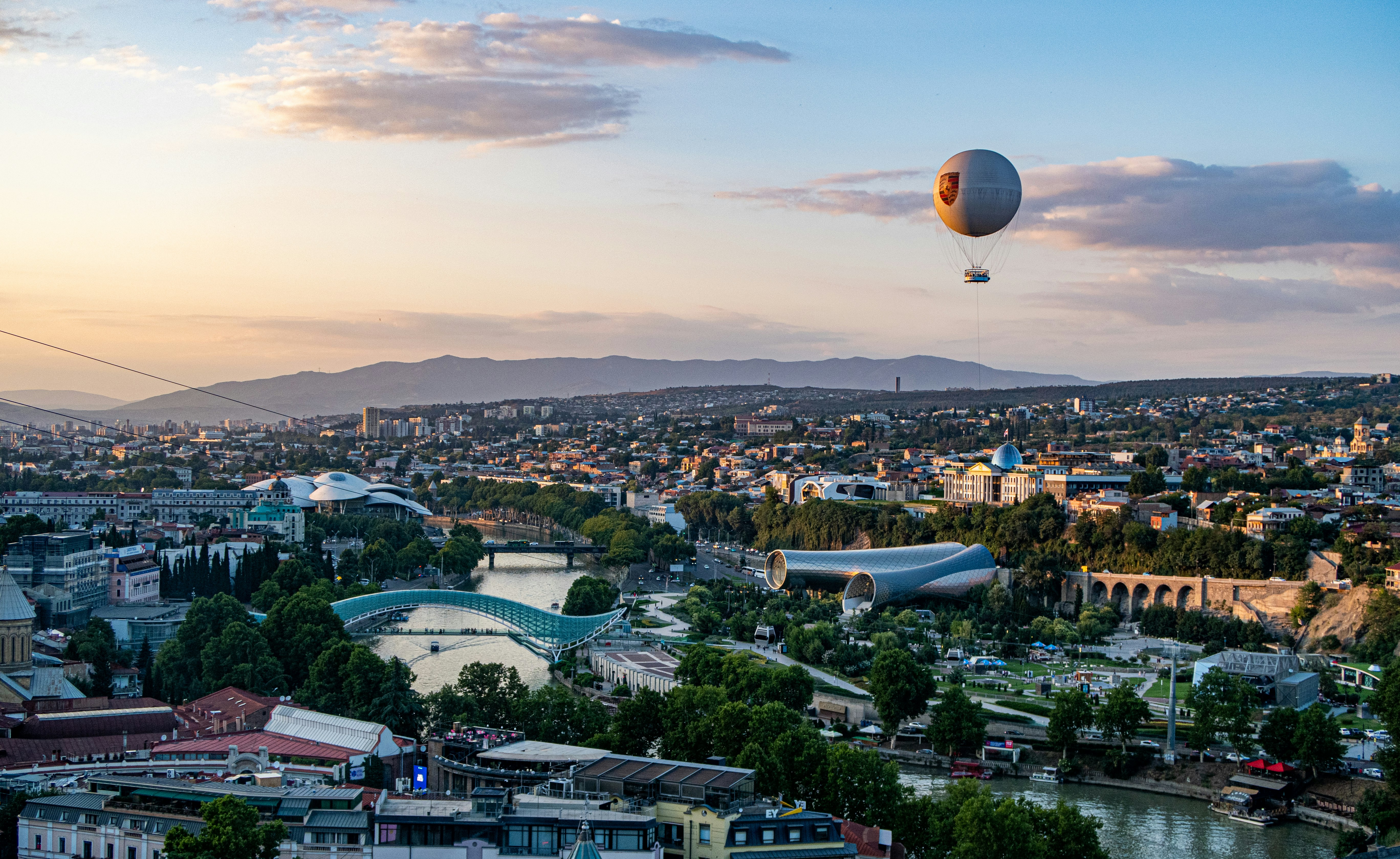 hot air balloon flying over city during daytime