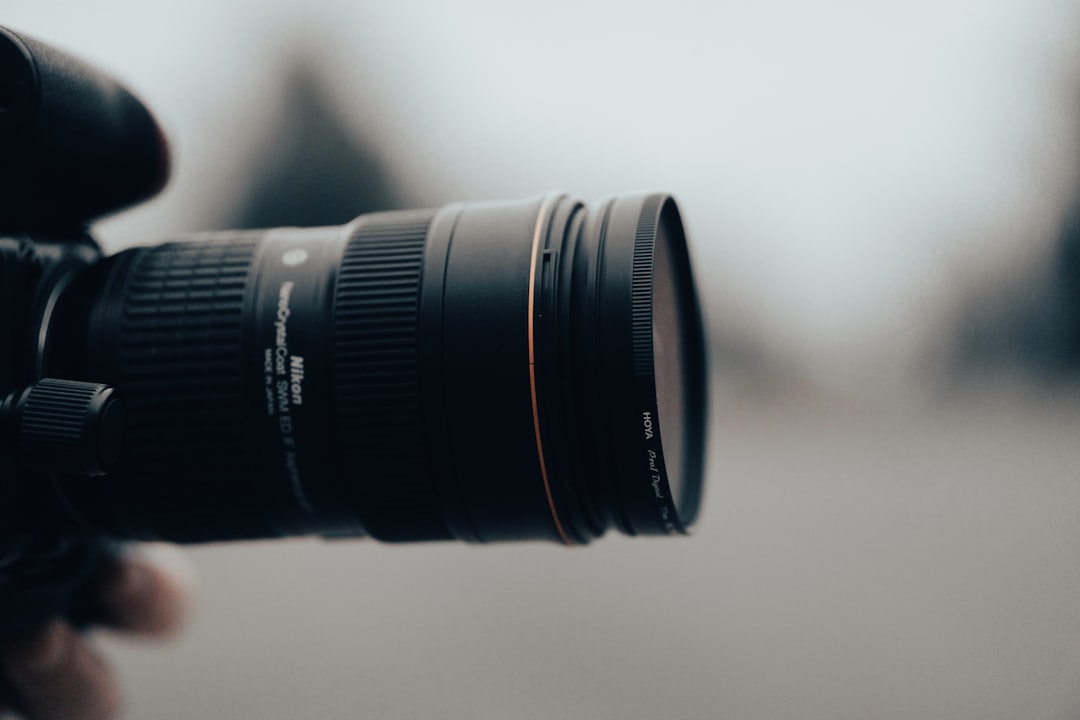 black camera lens on white table