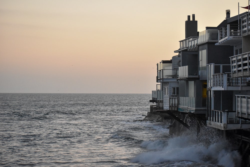 white and black building on sea during daytime