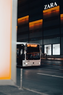 white bus on road during daytime