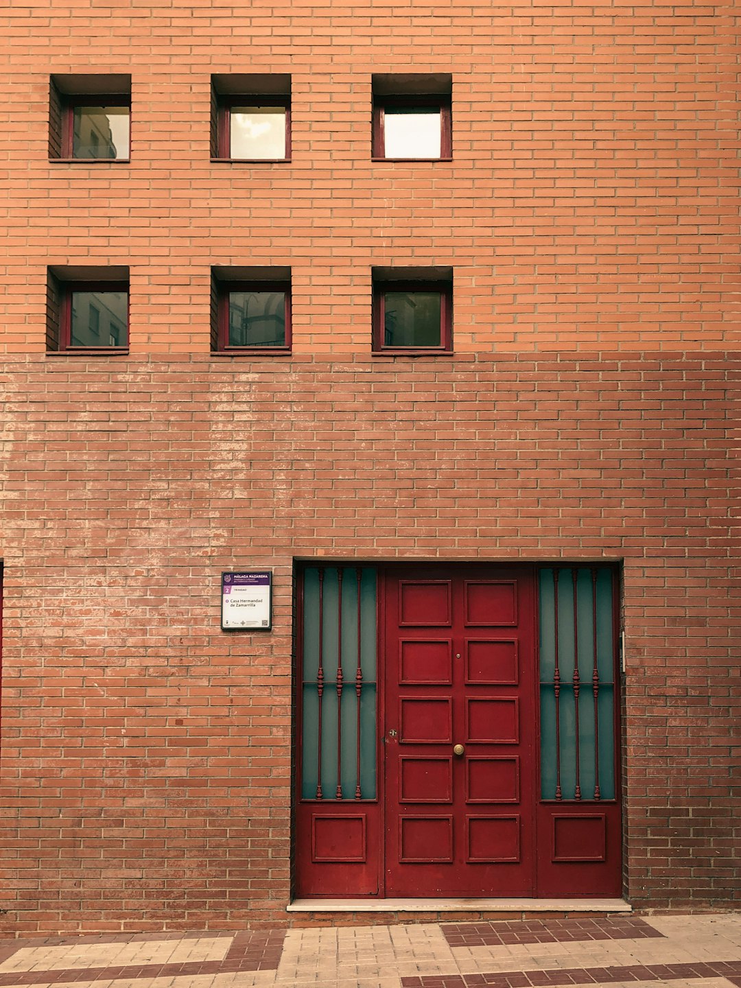 red brick building with red wooden door