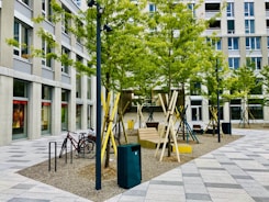brown wooden folding chairs near blue trash bin