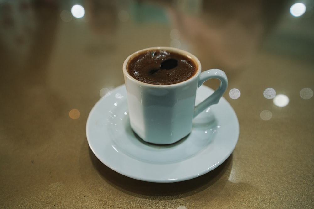 white ceramic mug on white ceramic saucer