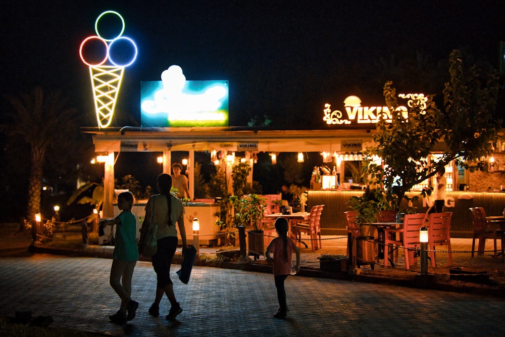 people walking on street during night time