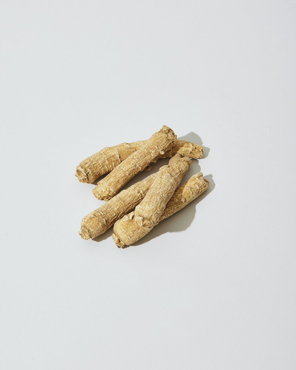 three pieces of ginger on a white surface