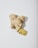 A piece of fresh ginger root with a few slices cut off lies on a light-colored surface. The ginger has a rough, textured outer skin and a yellowish interior.