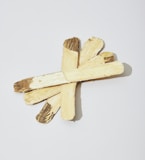 a cross made of wood on a white background