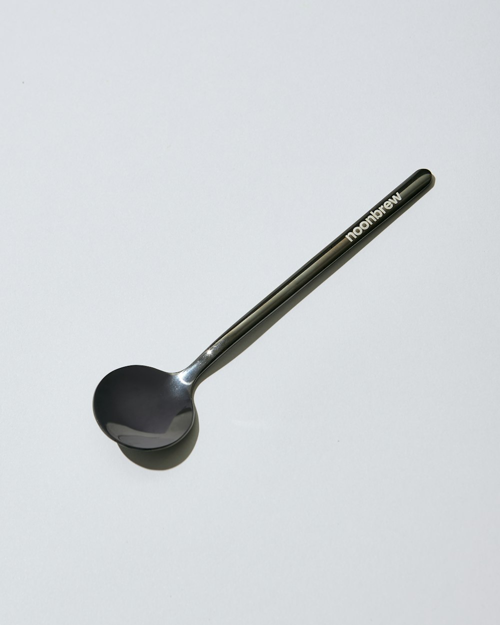 a spoon sitting on top of a white table