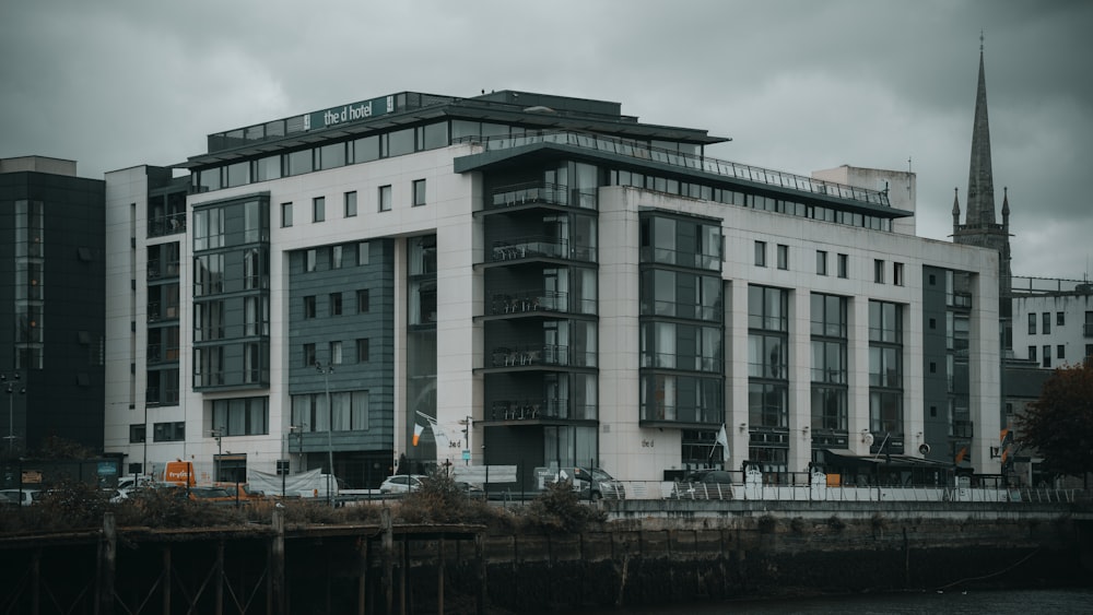 white concrete building near body of water during daytime