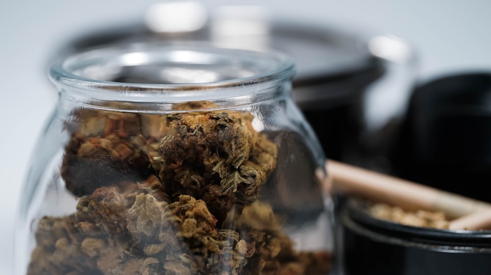 brown dried leaves in clear glass jar