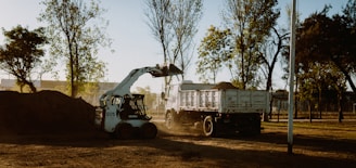 white and black utility truck on brown field during daytime