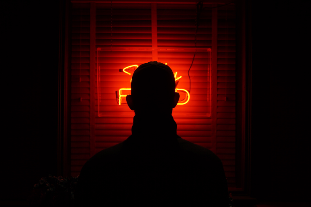 silhouette of man standing near window