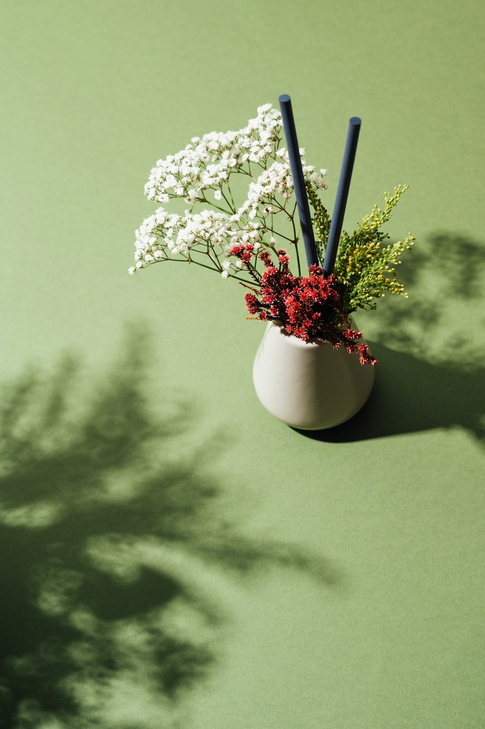 white flowers in white ceramic vase