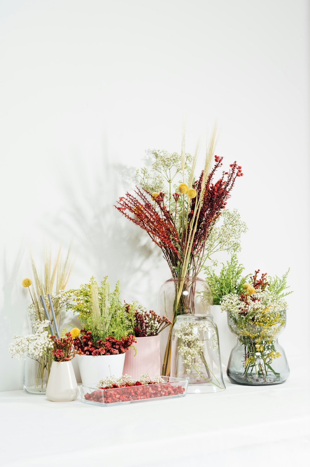 white and red flowers in clear glass vase