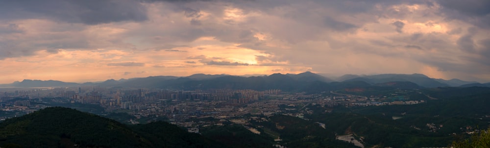 city skyline under cloudy sky during daytime