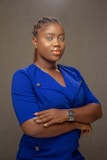 woman in blue button up shirt wearing gold round analog watch
