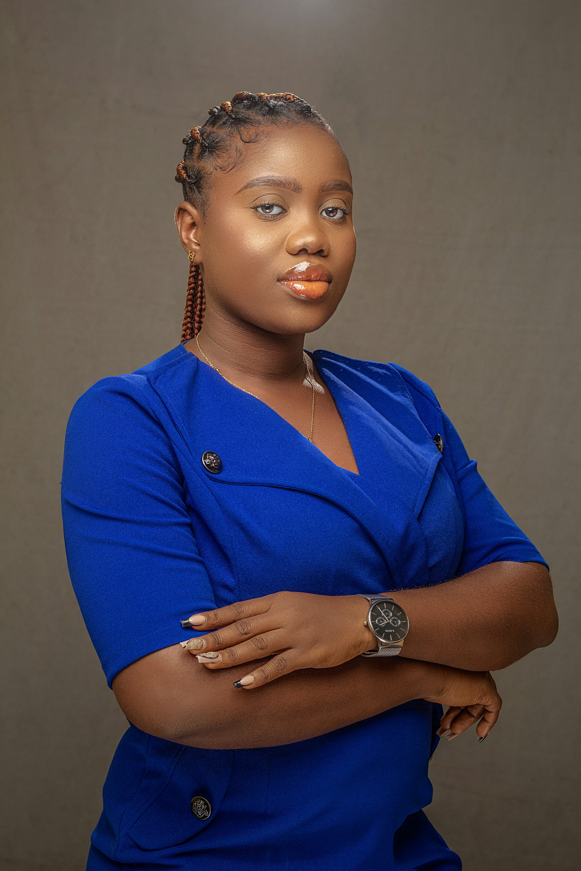 woman in blue button up shirt wearing gold round analog watch