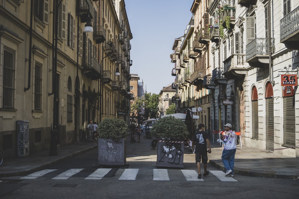 people walking on street between buildings during daytime