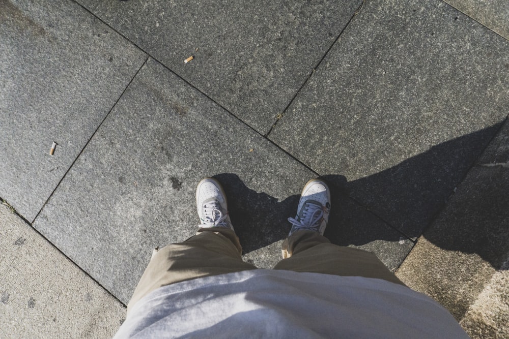 person in gray pants and black shoes