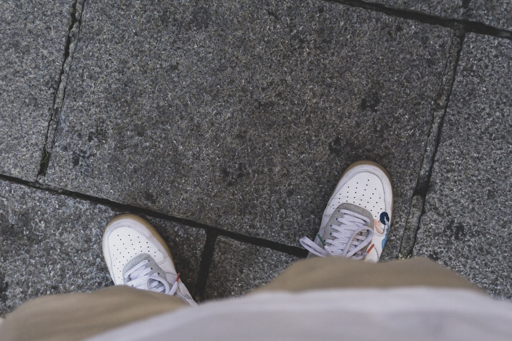 person wearing white converse all star high top sneakers