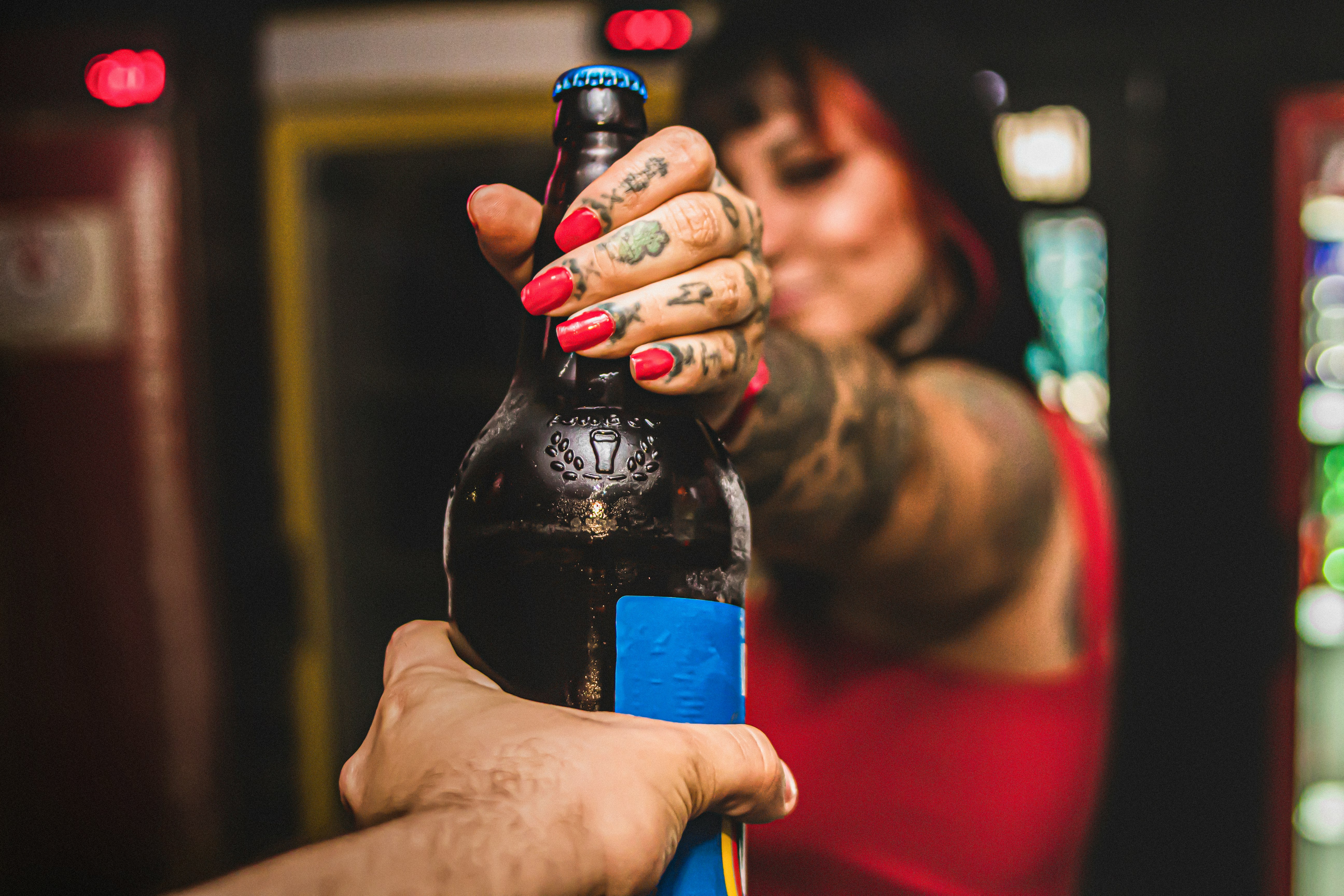 person holding blue labeled bottle