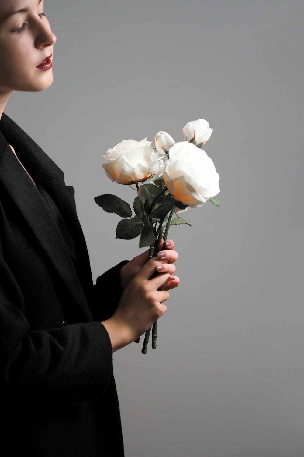 person holding white petaled flower