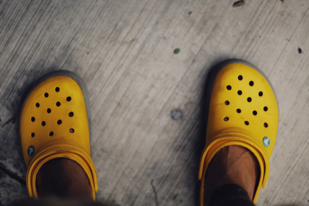 person wearing yellow rubber clogs