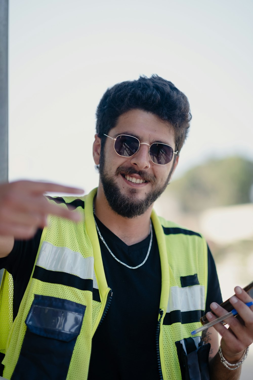 man in green and black adidas jersey shirt wearing black sunglasses