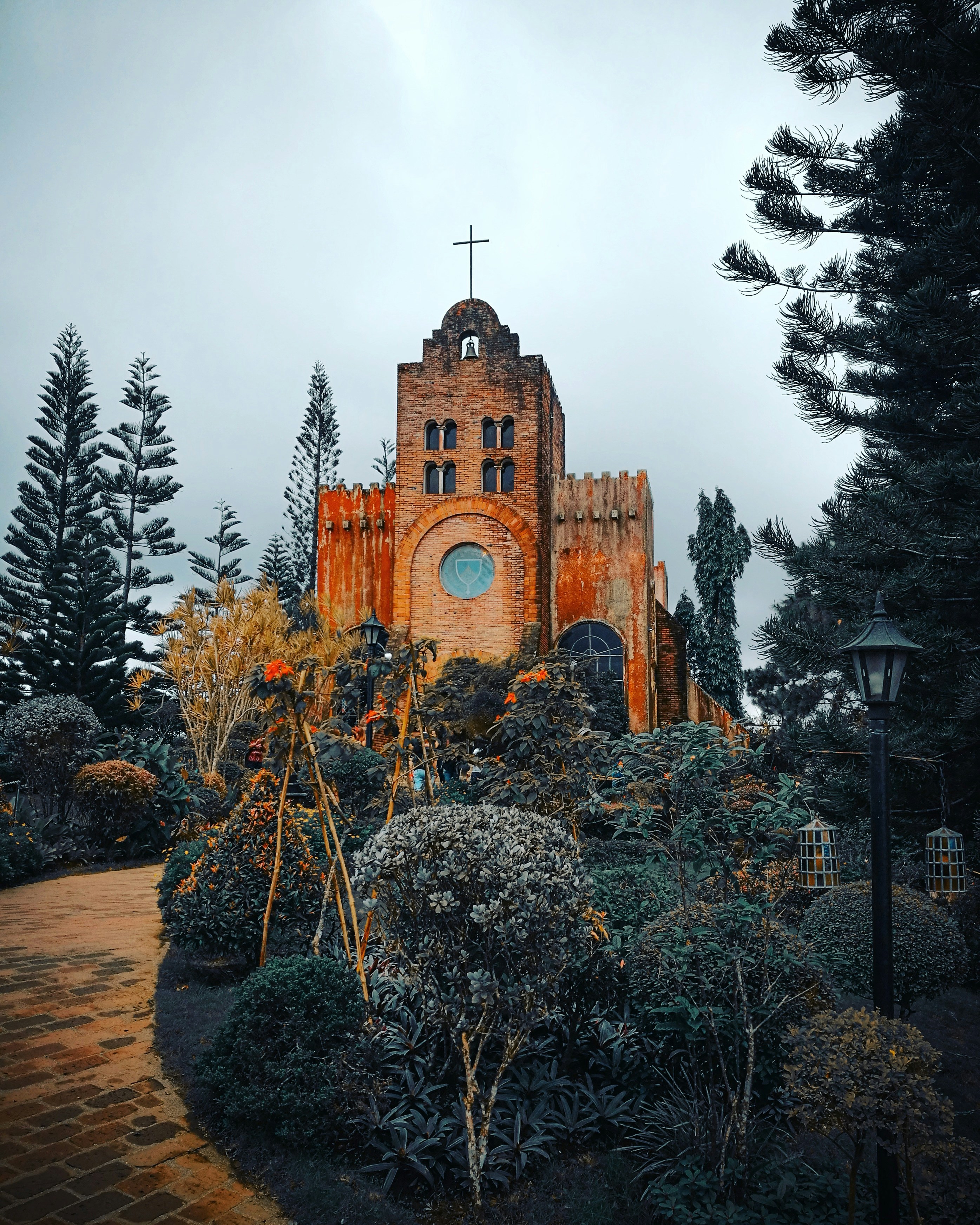 brown concrete church surrounded by trees during daytime