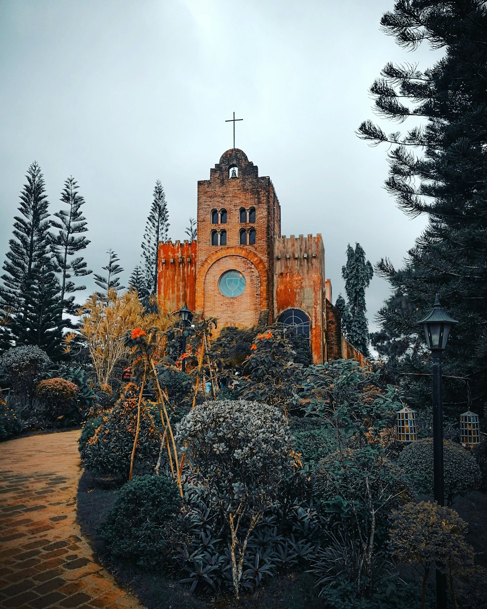 brown concrete church surrounded by trees during daytime