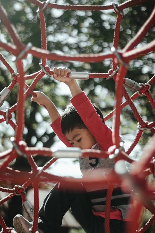A child on a playground climbing structure, a representative image rather than one of these stops