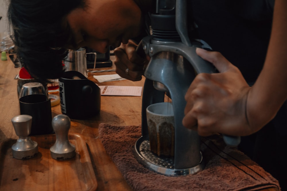 person holding black and silver vacuum flask